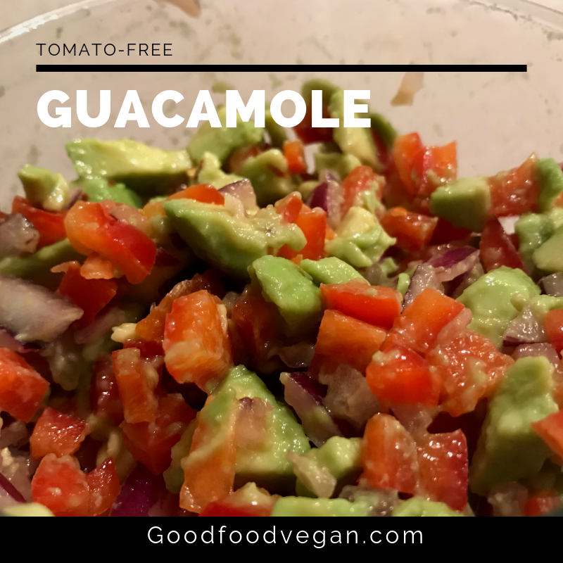Dish of guacamole salsa with diced avocado, red peppers, and onions. No tomatoes