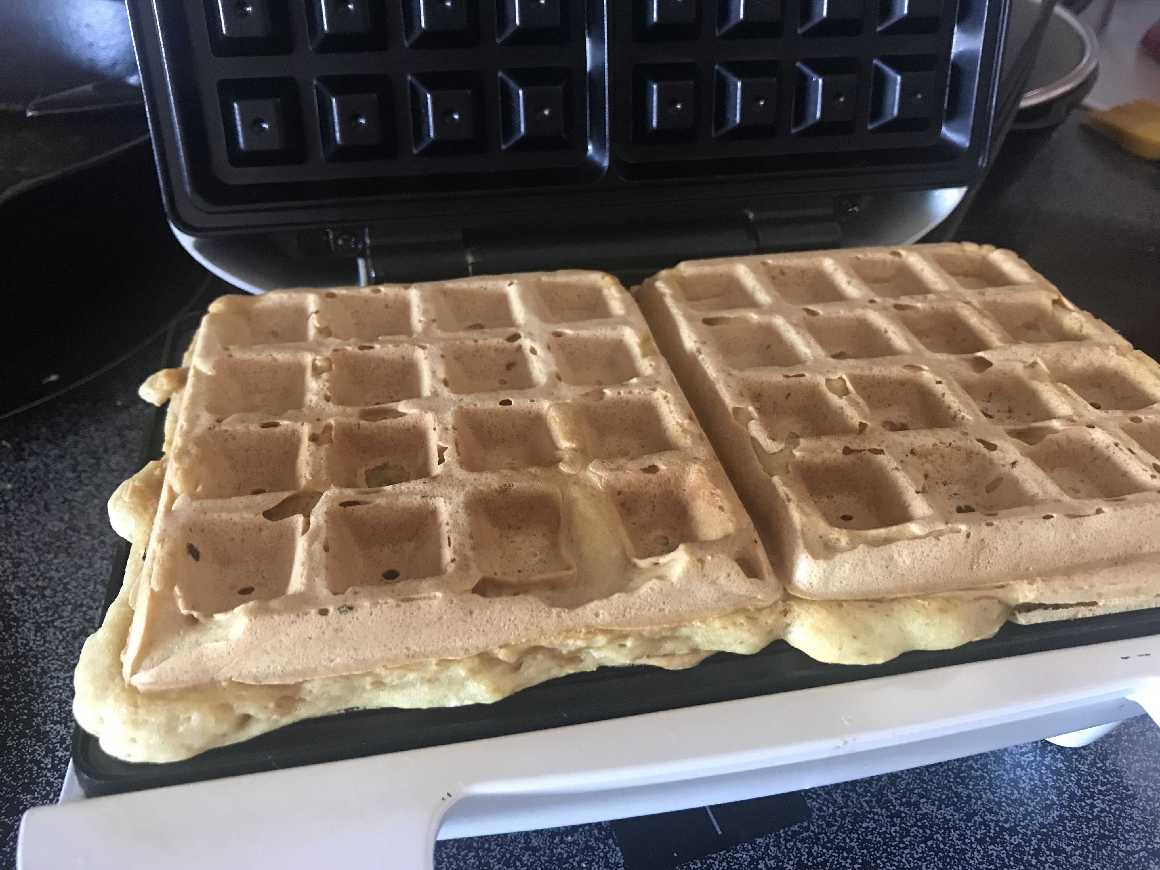 cooked light and fluffy vegan waffles ready to remove from waffle iron