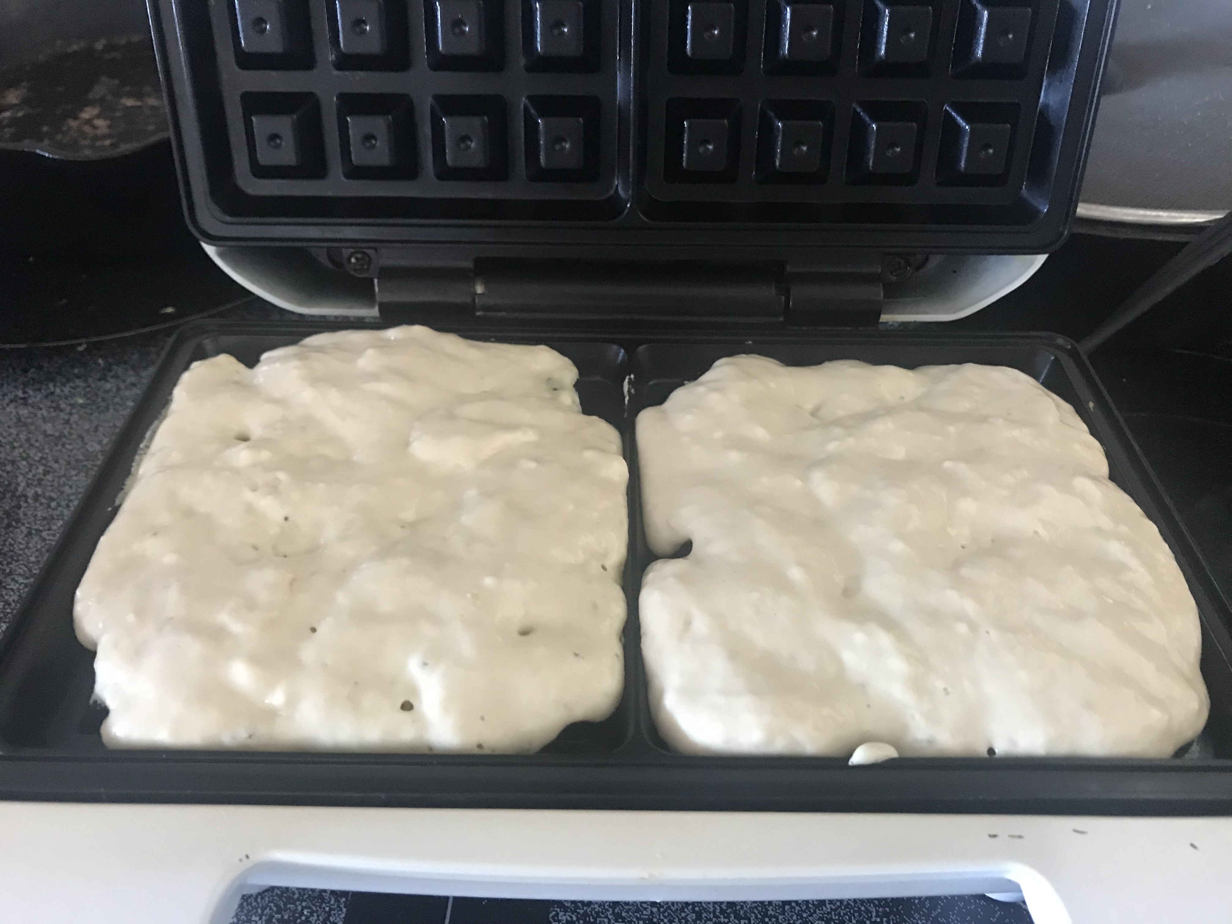 waffle batter in waffle iron ready to cook