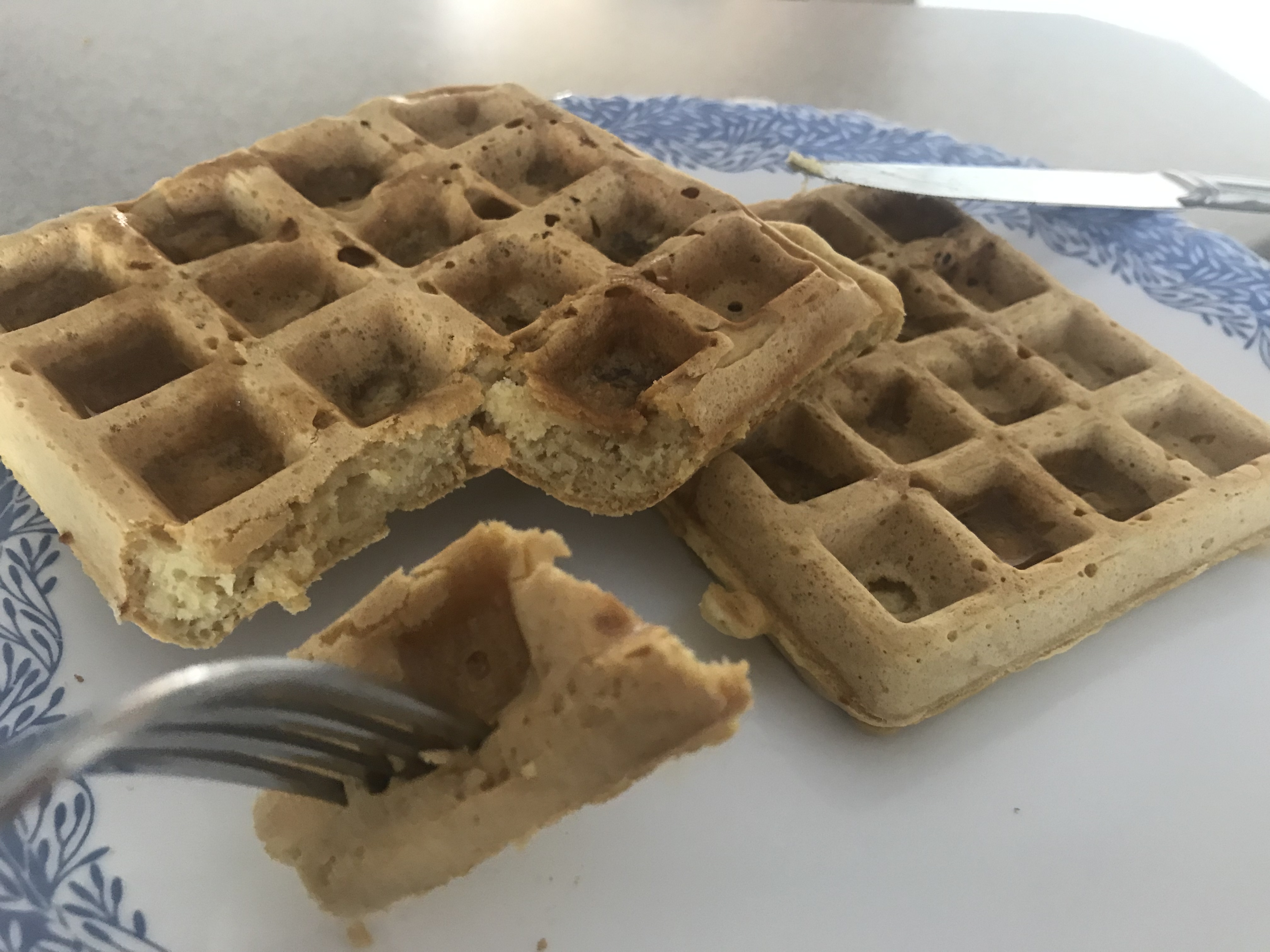 a piece of light and fluffy vegan waffles on a fork