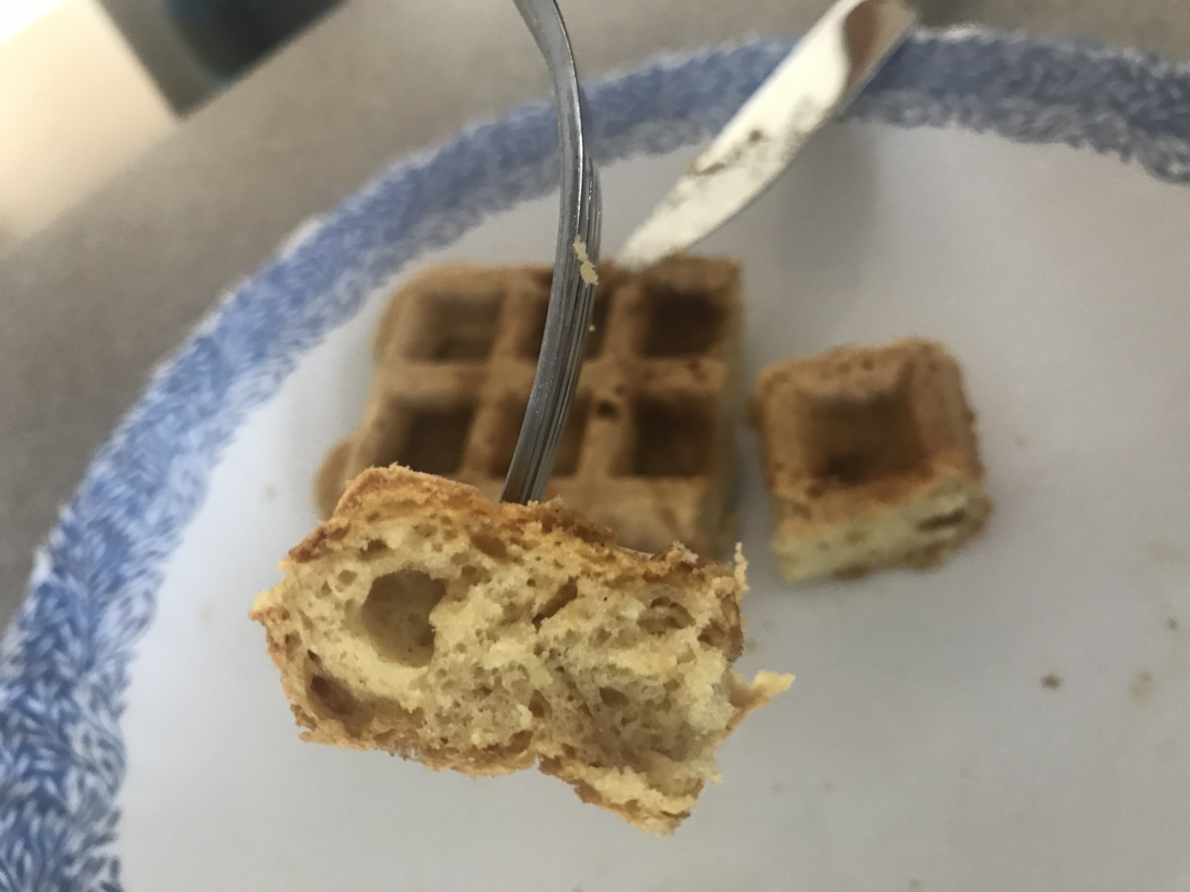 closeup of a piece of waffle on a fork