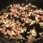 onions and garlic in frying pan