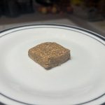 Oat and date square sitting on a plate