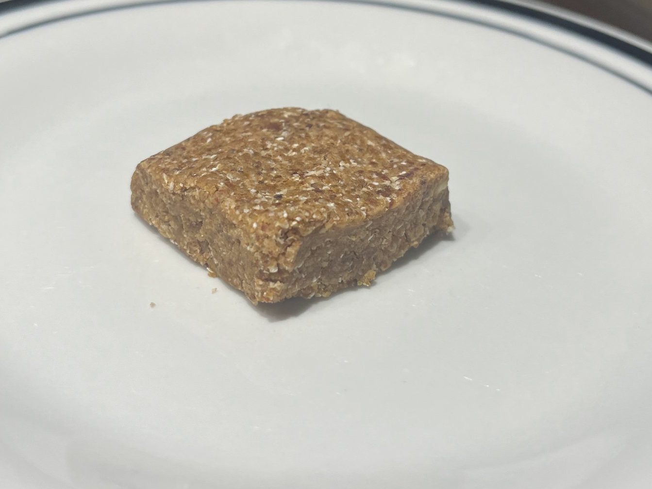 Oat and date square sitting on a plate